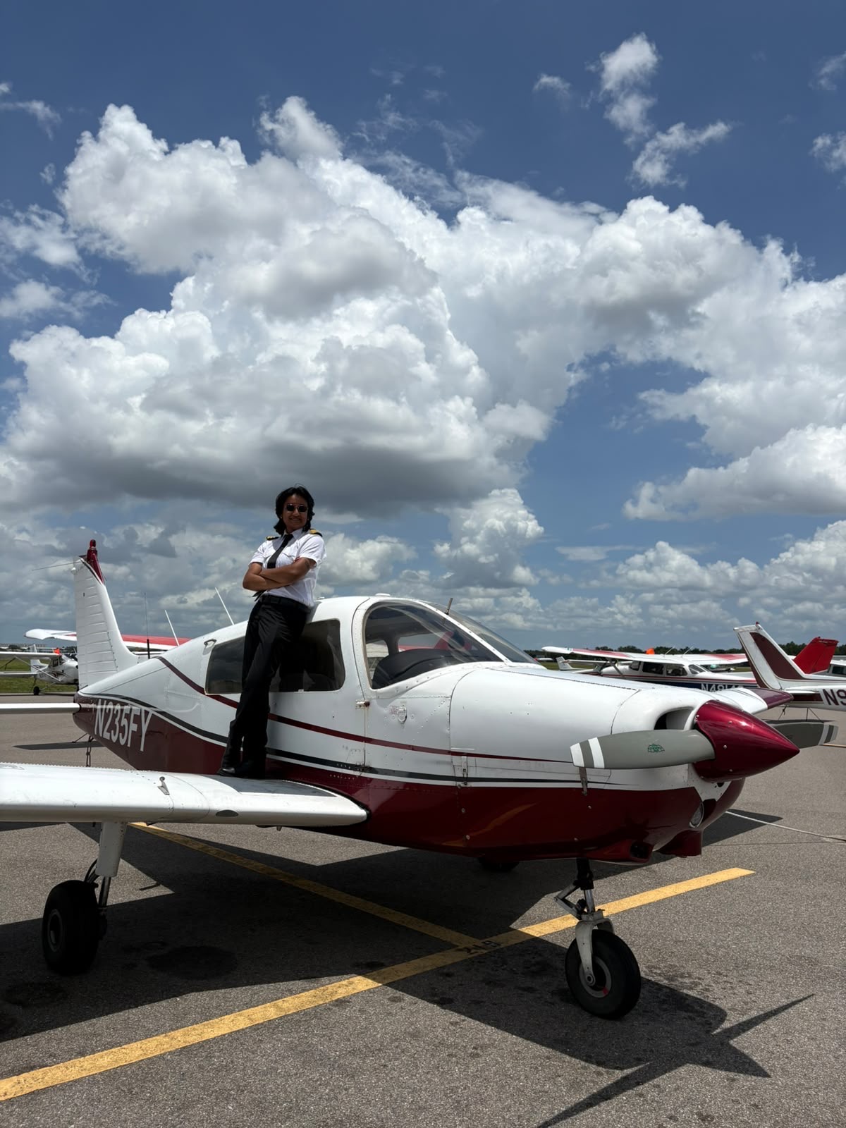 Pilot standing on training aircraft